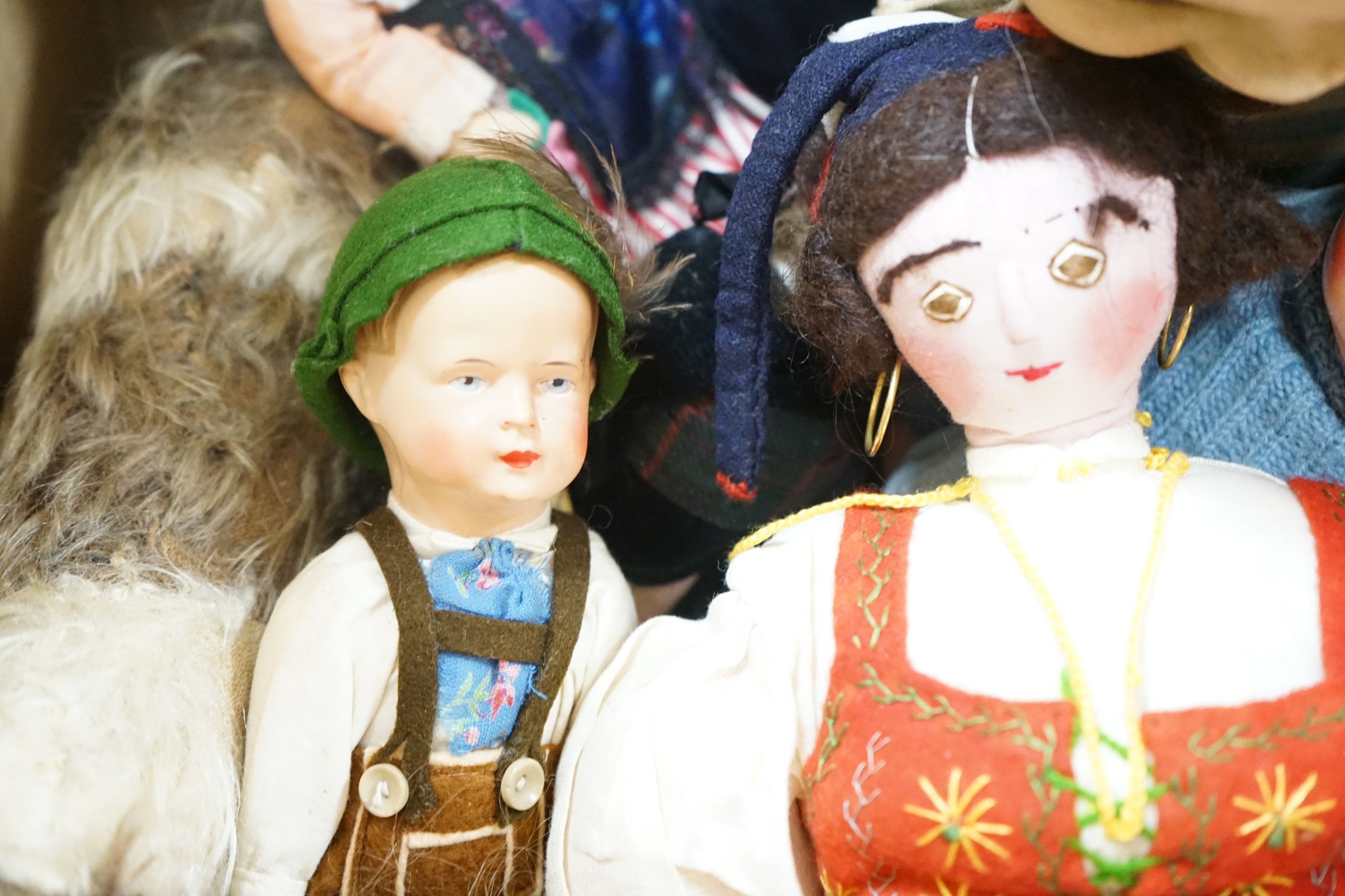 A collection of dolls and two soft toys
